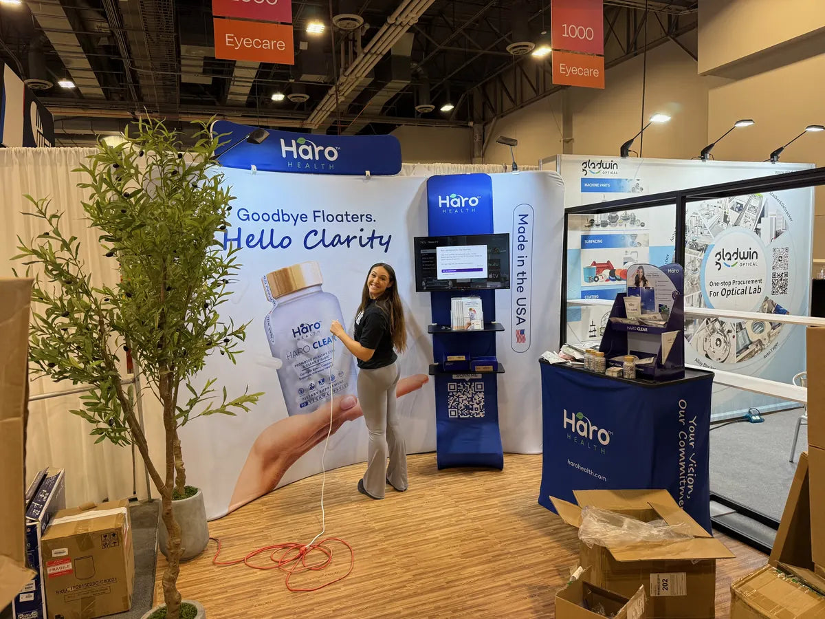 A smiling exhibitor beside the Haro Clear display